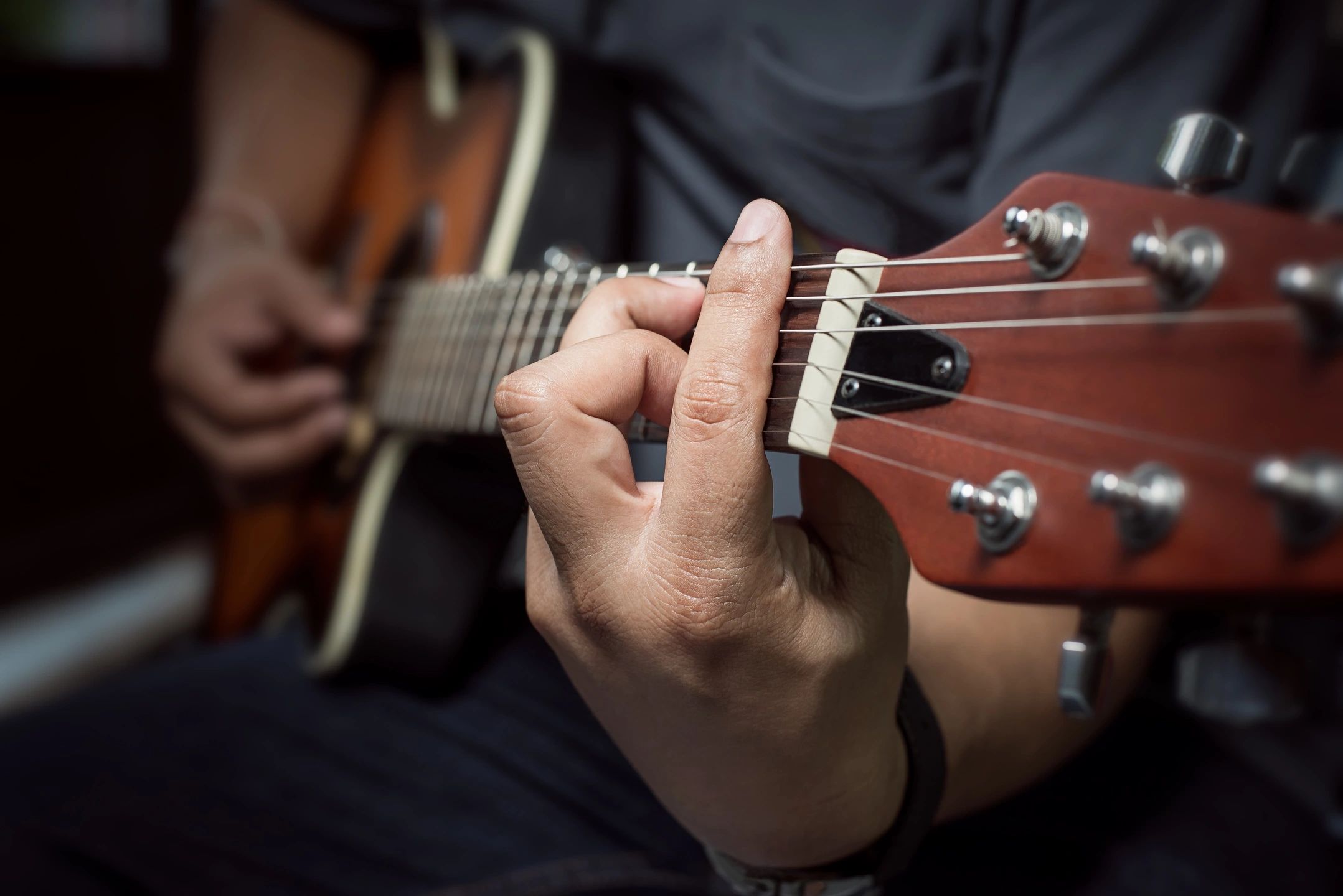 Guitarist playing in a studio loft space